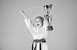 Girl little child in white kimono with belt. Karate fighter child. Karate sport concept. Self defence skills. Karate