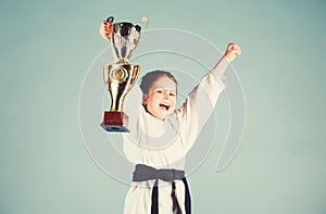 Girl little child in white kimono with belt. Karate fighter child. Karate sport concept. Self defence skills. Karate