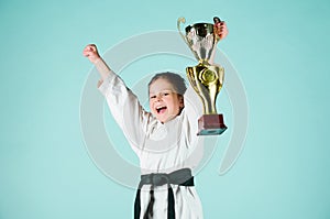 Girl little child in white kimono with belt. Karate fighter child. Karate sport concept. Self defence skills. Karate