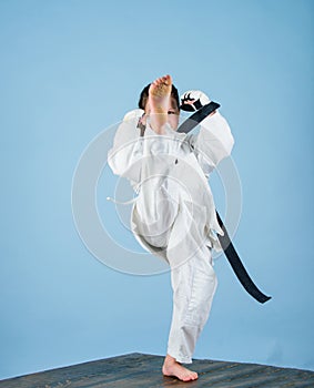 Girl little child in white kimono with belt. Karate fighter ready to fight. Karate sport concept. Self defence skills