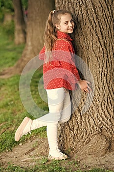 Girl little cute child enjoy peace and tranquility at tree trunk. Calm and peaceful. Life balance. Peaceful mood. Good