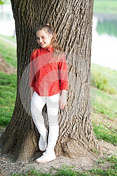 Girl little cute child enjoy peace and tranquility at tree trunk. Place of power. Peaceful place. Find peace and relax