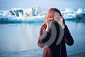 Girl with little iceberg in Iceberg Field, Iceland photo