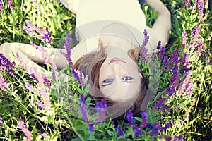 Girl liyng on spring grass