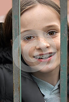 Girl locked in behind a fence