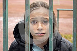 Girl locked in behind a fence