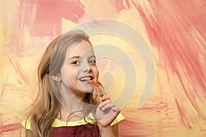 Girl with long blond hair eating red chilly pepper