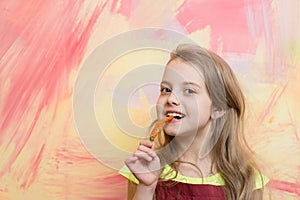 Girl with long blond hair eating red chilly pepper