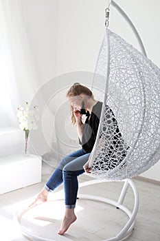 Vertical photo of a pretty young girl in a white studio