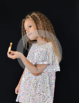 girl with long blond hair stands with cookies