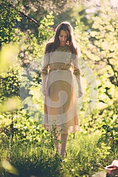Girl in a long dress in the sun. Post processing photo