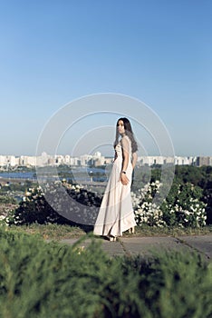 Girl in a long dress walking in the botanical garden