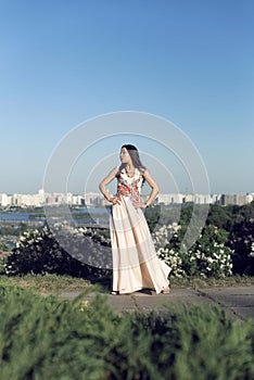 Girl in a long dress walking in the botanical garden