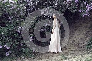 Girl in a long dress walking in the botanical garden