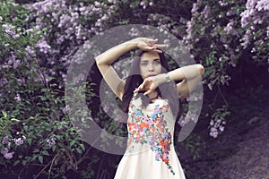 Girl in a long dress walking in the botanical garden