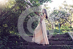 Girl in a long dress walking in the botanical garden