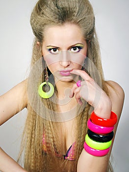 Girl with a long fair hair in bright bracelets