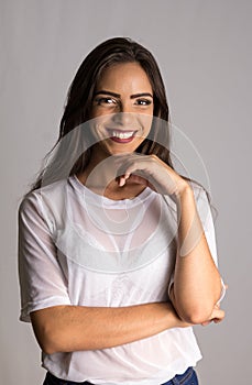 Girl with long hair with arms crossed and smiling with confidence