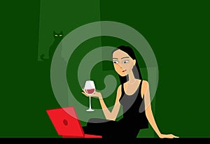 A girl with long hair in a black dress with a glass of wine in her hand is watching a video on a laptop.