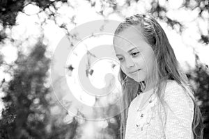 Girl with long hair on calm face, nature background defocused. Girl with tender braid hairstyle. Child girl with braid