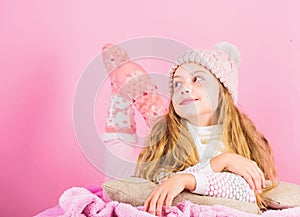 Girl long hair dream pink background. Kid dreamy face wear knitted accessory. Kid girl wear cute knitted fashionable hat