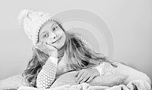 Girl long hair dream pink background. Kid dreamy wear knitted hat. Winter rest and relax. Winter season concept. Winter