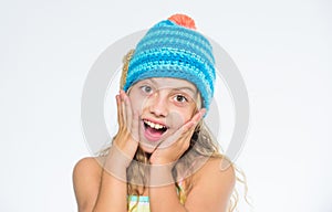 Girl long hair happy face white background. Kid wear warm soft knitted blue hat. Difference between knitting and crochet