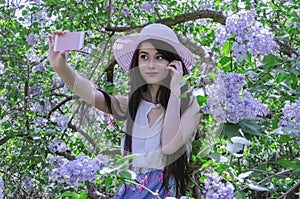 Girl with long hair in a hat makes a video call