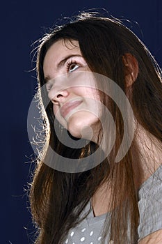 Girl with long hair looks up