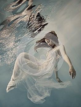 Girl with long hair swims underwater