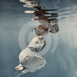 Girl with long hair swims underwater