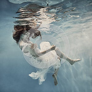 Girl with long hair swims underwater