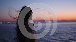 Girl with long hair watches the horizon in Albufera