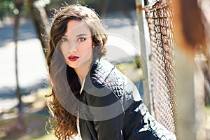 Girl with long hair wearing leather jacket