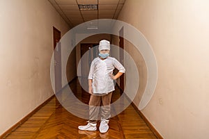 A girl in a long hallway wearing halotherapy clothes. Medicine