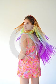 A girl with a long wavy hair painted in rainbow colors. Tunic hair kanekalon