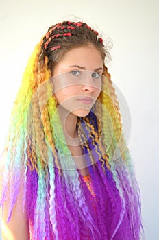 A girl with a long wavy hair painted in rainbow colors. Tunic hair kanekalon