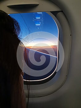 Girl lookin at sky from the plane photo