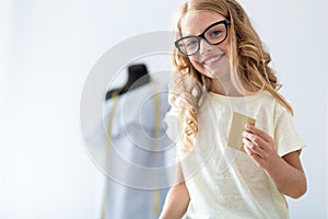 Girl looking at camera and holding card