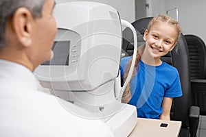 Girl looking at camera and laughing while checking vision