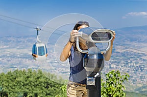 Girl looking at coin operated binocular