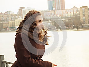 Girl looking into distance with sity on the back