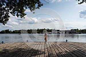 Girl looking into Dow's lake at the Rideau Canal Western Pathway during summer. Ottawa, Ontario, Canada.