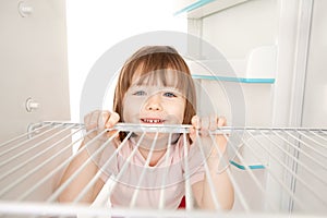 Girl looking in empty fridge