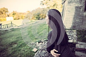 Girl looking forward in old castle