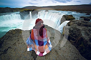 Girl looking at Godafoss waterfall, Iceland