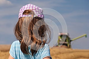 Girl looking at harvester