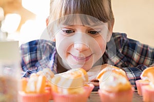 Girl Looking Hungrily At Home Made Cup Cakes photo