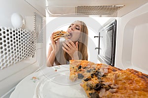 The girl looking in a microwave