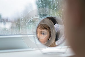 Girl looking into the mirror